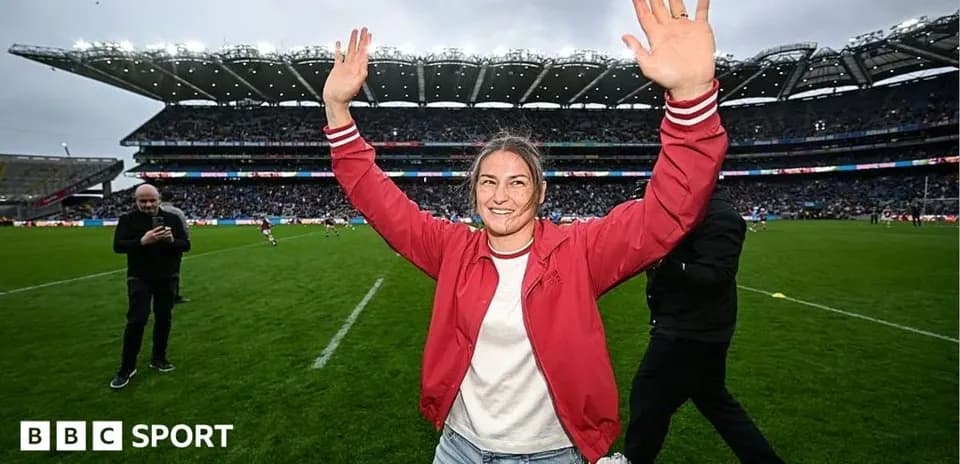 Woman celebrating on the field at a stadium