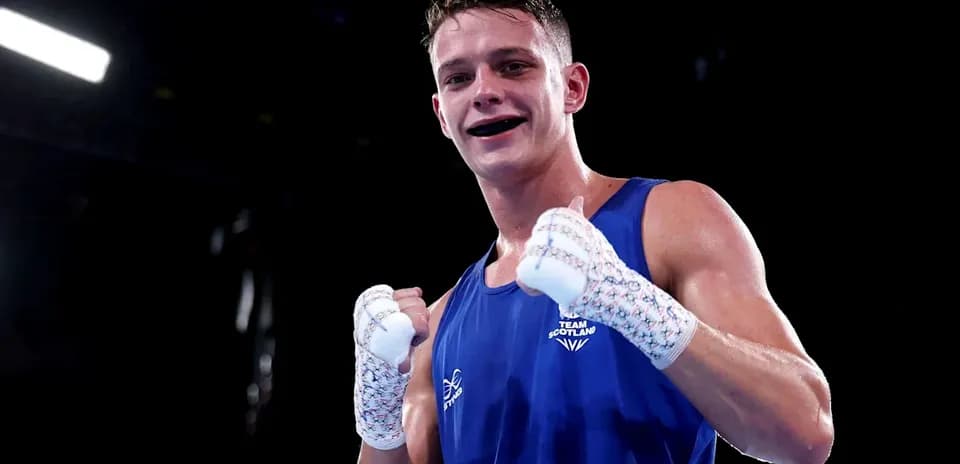 Boxer in blue celebrating victory after match