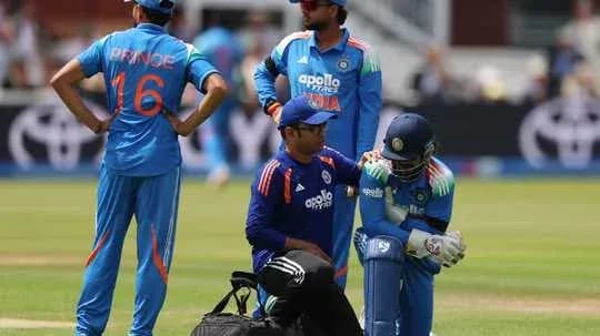 Cricket players attending to injured teammate on field