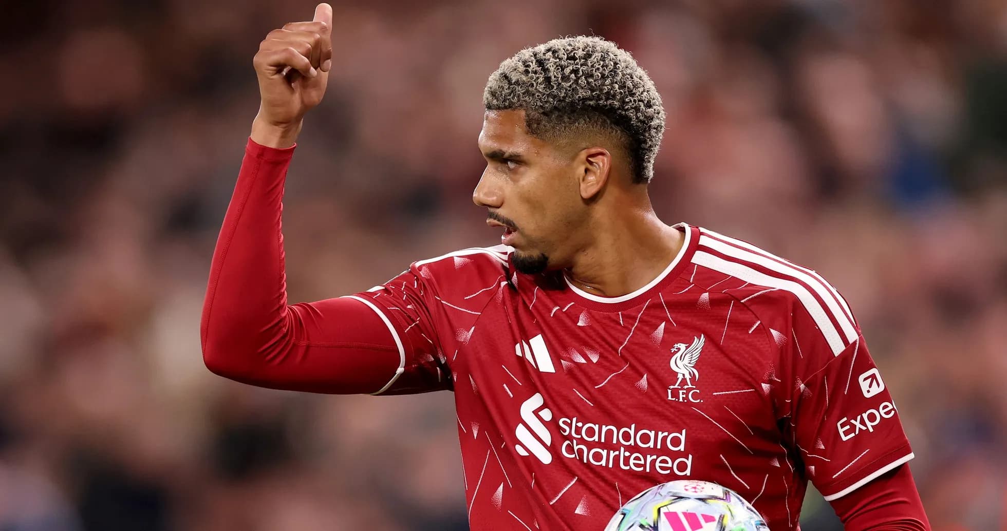 Player gesturing during match in Liverpool jersey