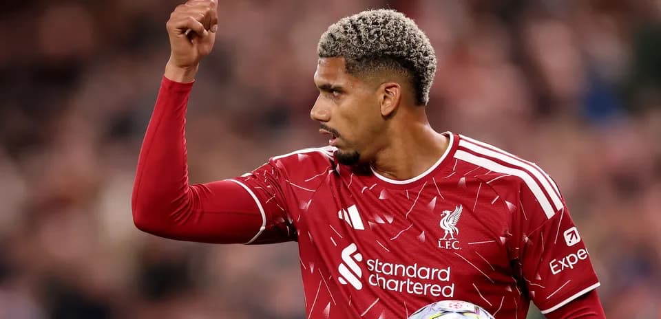 Player gesturing during match in Liverpool jersey
