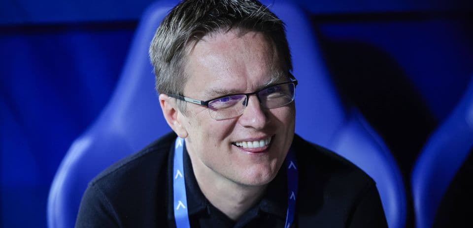 Man smiling in a sports venue seating area