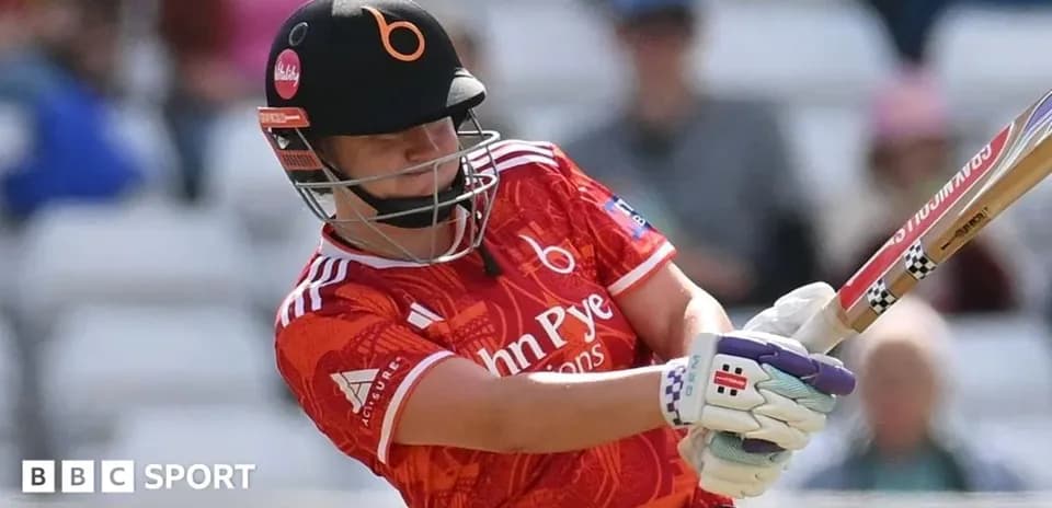 Batter striking the ball in cricket match