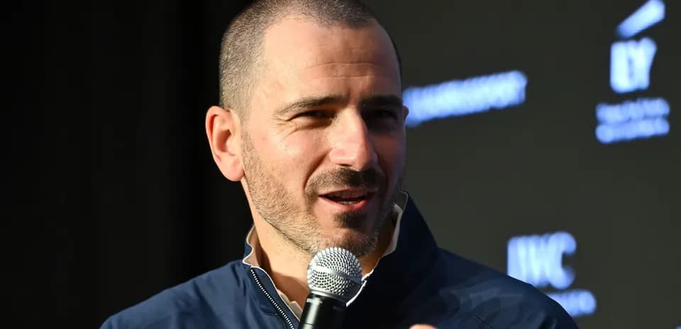 Man speaking into a microphone at an event