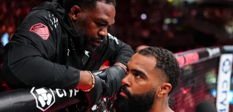 Coach advising fighter at the cage during match