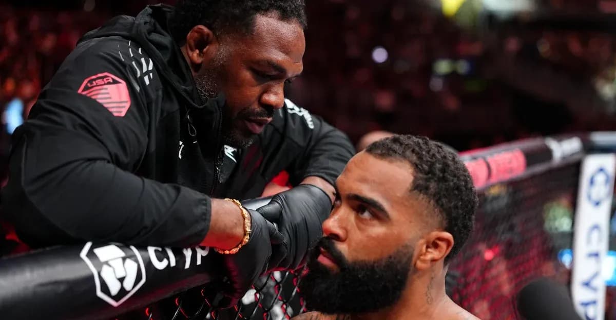 Coach advising fighter at the cage during match
