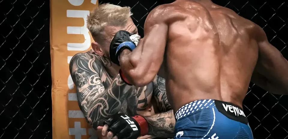 Two fighters engaged in a close exchange during match