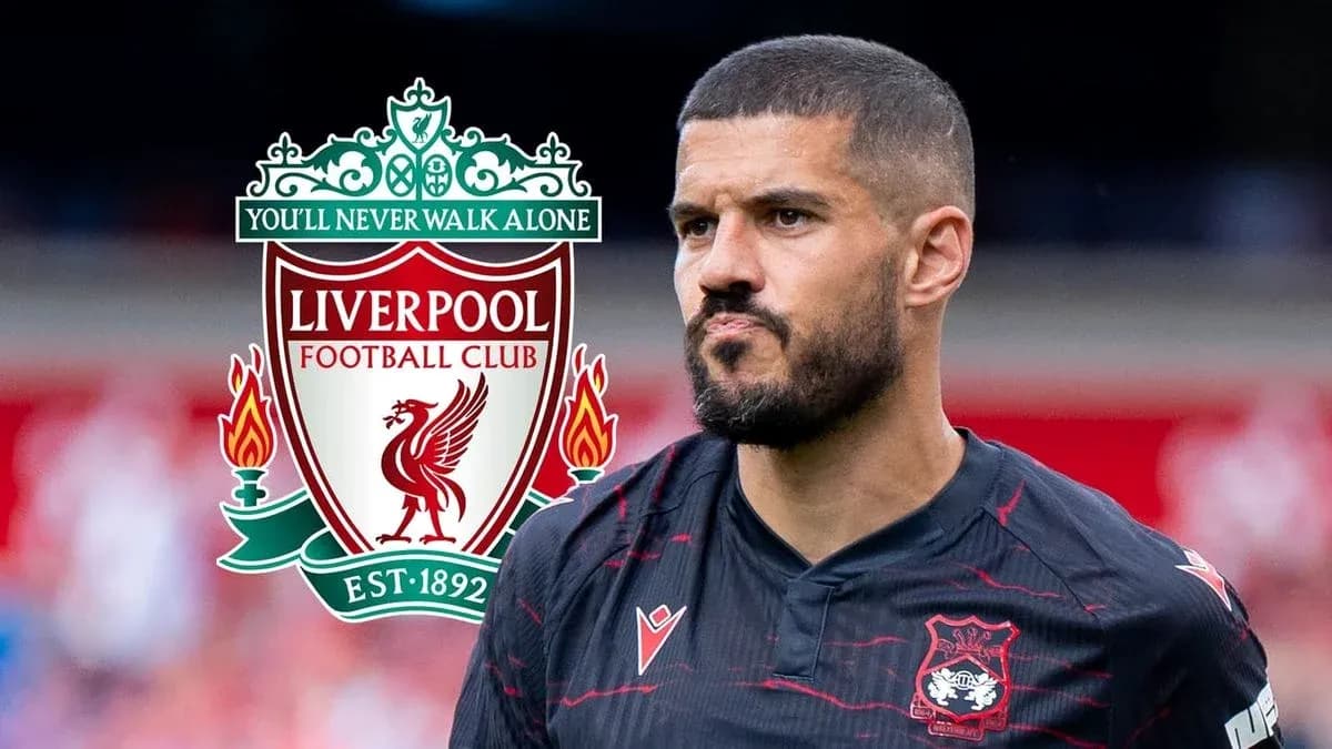 Player in Liverpool kit with club logo in background