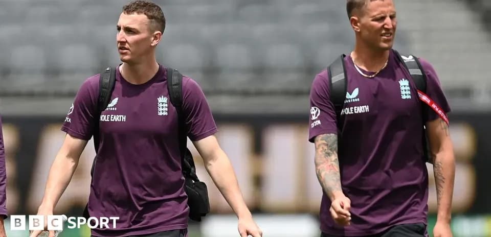 Two England cricket players walking on field