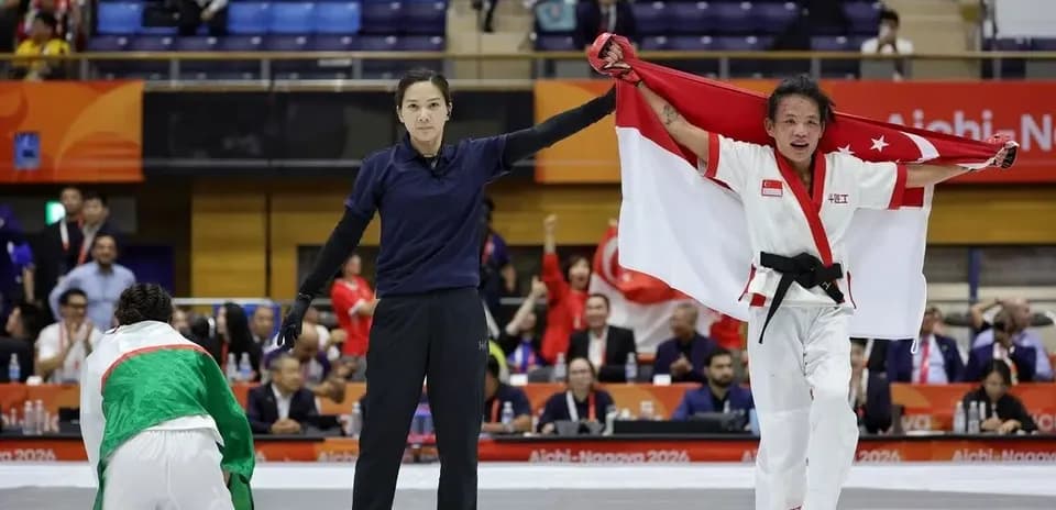 Athlete celebrating victory with national flag at competition