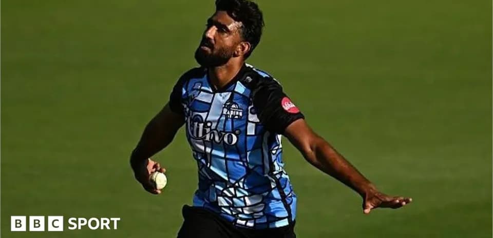 Cricketer bowling during a match on field