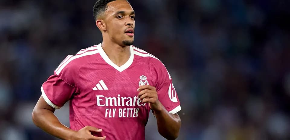 Player in pink Real Madrid jersey running on field