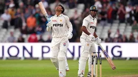 Two cricketers on field during match at stadium