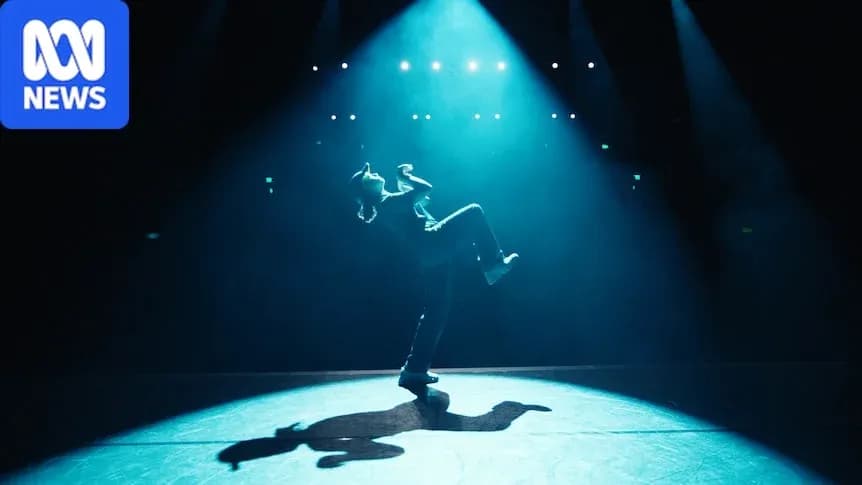 Dancer performing under dramatic stage lighting