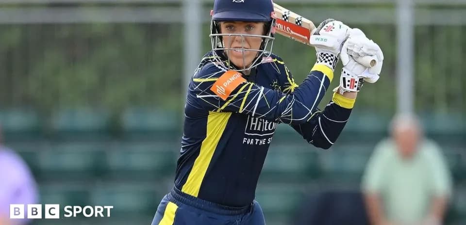 Cricketer preparing to bat on the field