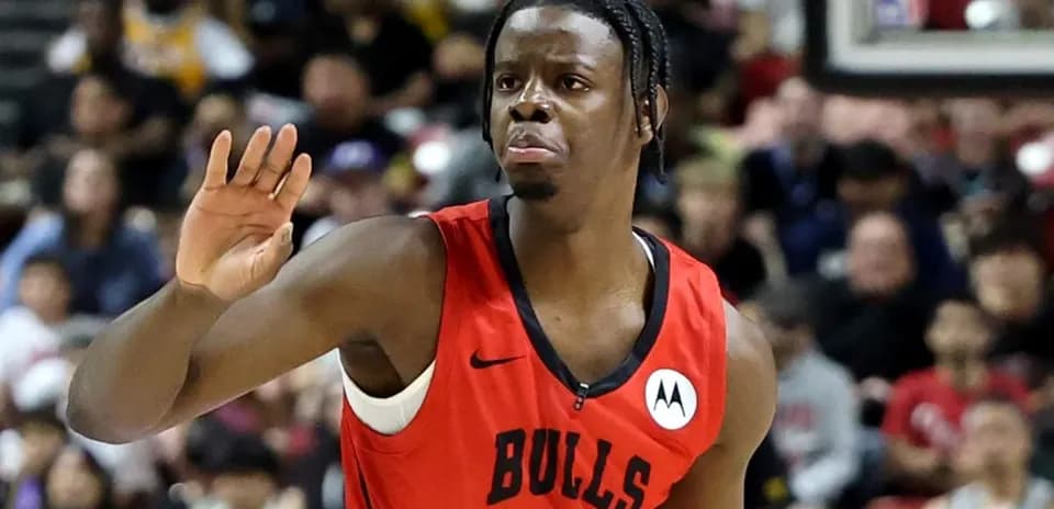 Player gesturing during basketball game in red jersey