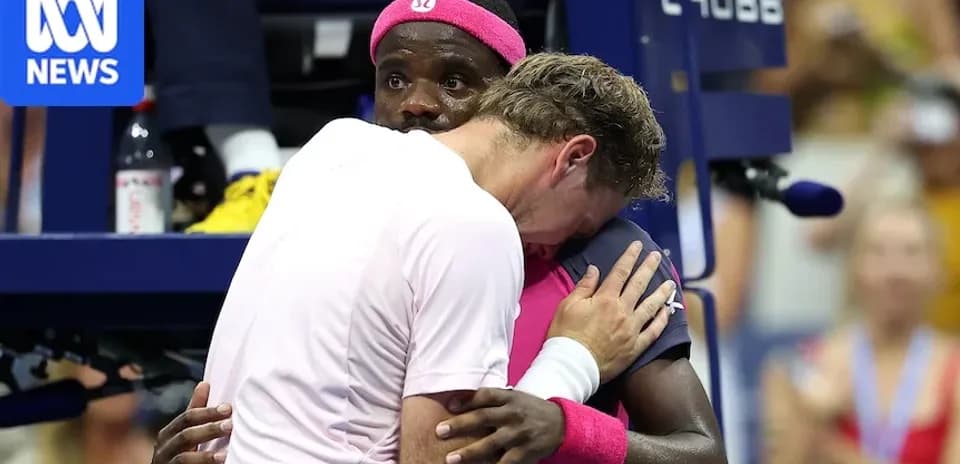 Two tennis players embracing during a match