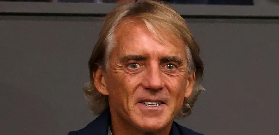 Man with light brown hair smiling at event