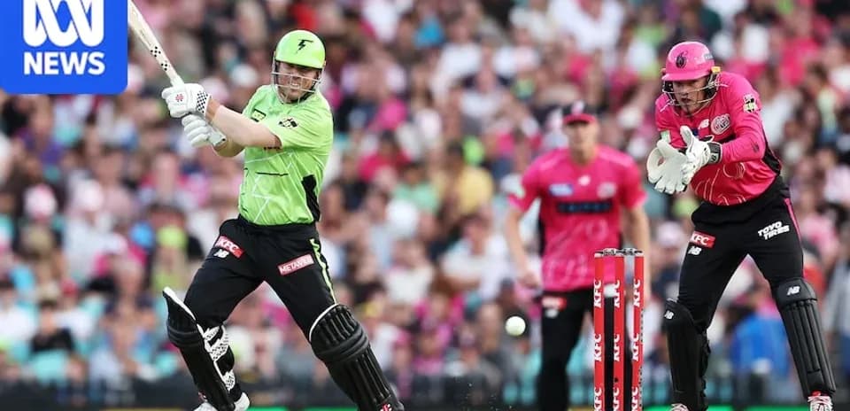 Batsman striking ball with wicketkeeper ready