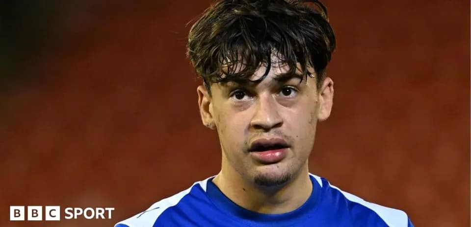 Player in blue jersey looking at the camera