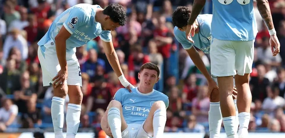 Manchester City players checking on injured teammate