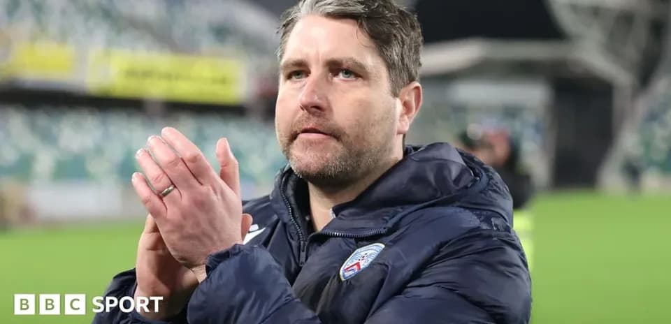 Coach clapping hands in stadium after match