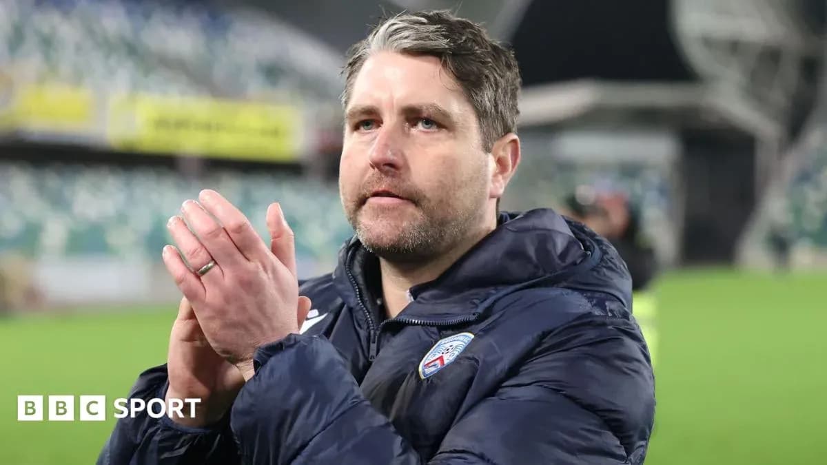 Coach clapping hands in stadium after match