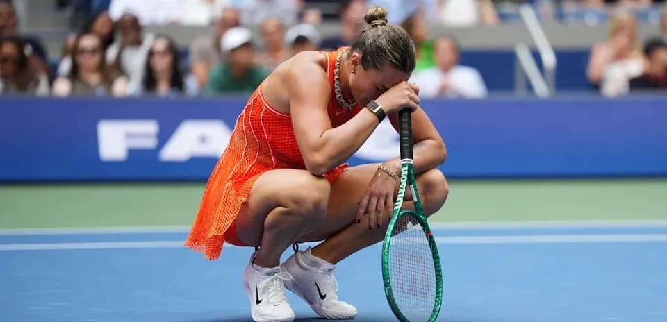 Player kneeling on court holding racket during match