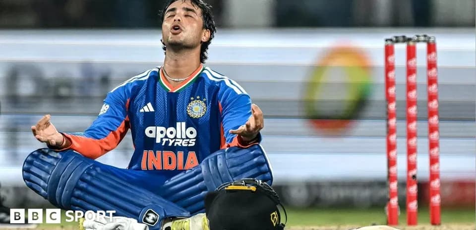 Cricketer sitting on the ground in uniform