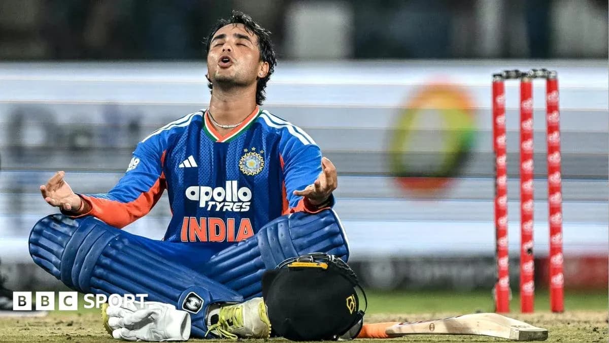Cricketer sitting on the ground in uniform