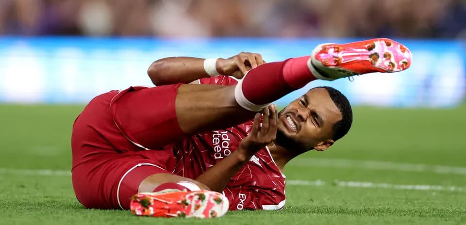 Player lying on pitch holding injured leg