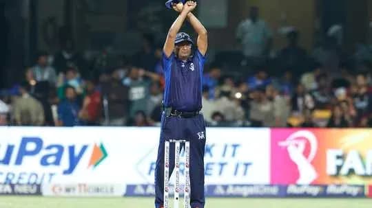 Umpire signaling for a decision during cricket match