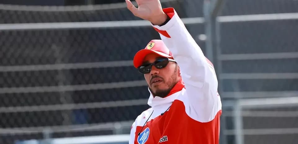 Driver waving to fans during race event