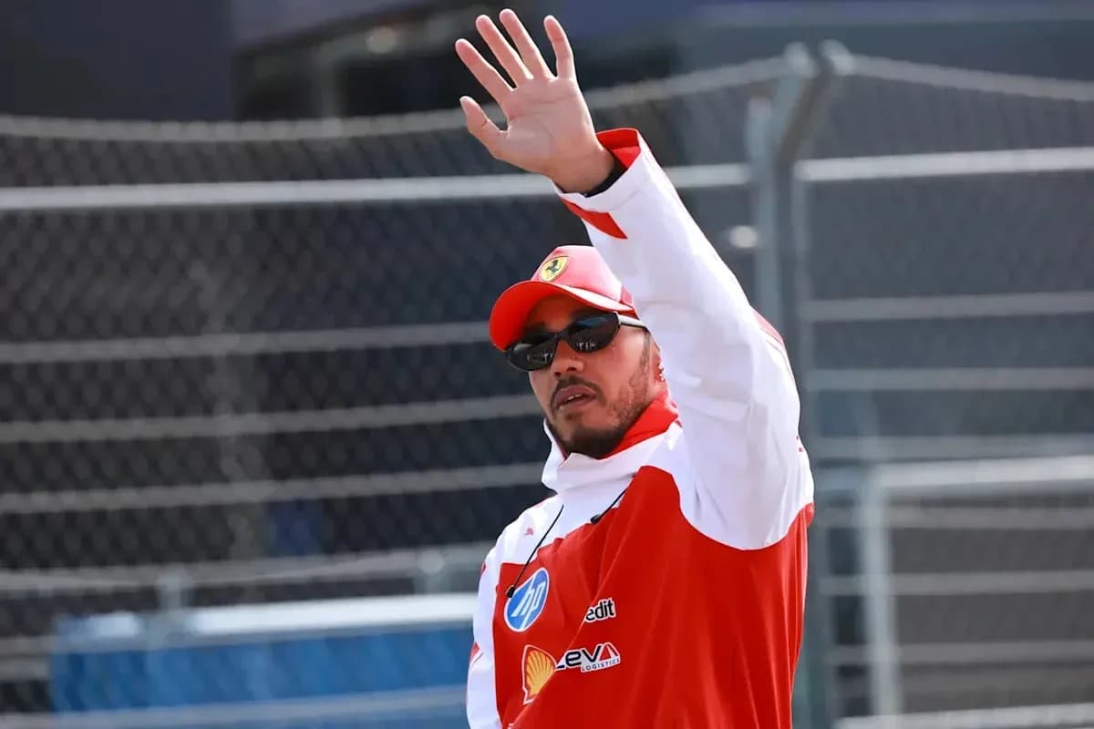 Driver waving to fans during race event