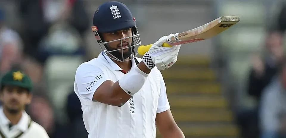 Cricketer celebrating a run with raised bat