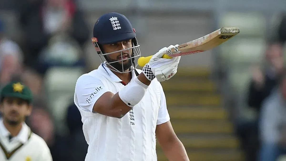 Cricketer celebrating a run with raised bat