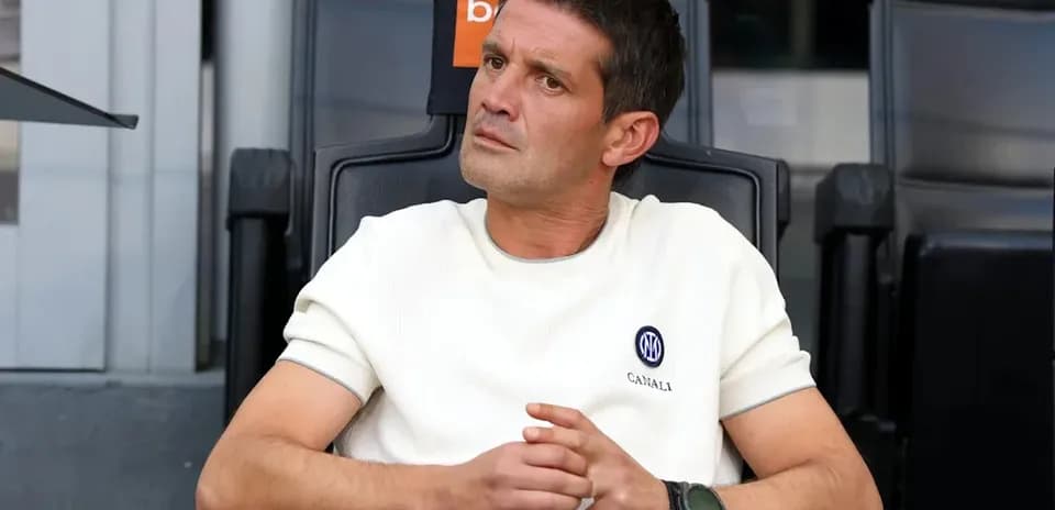 Coach sitting in dugout during match