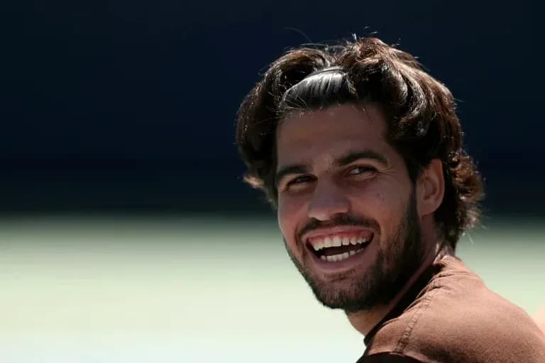 Tennis player smiling during a practice session