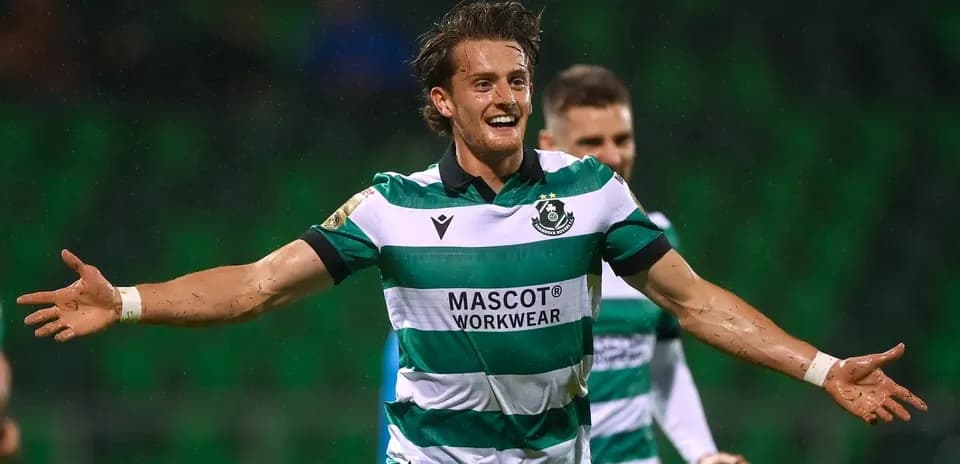 Player celebrating goal in striped green jersey