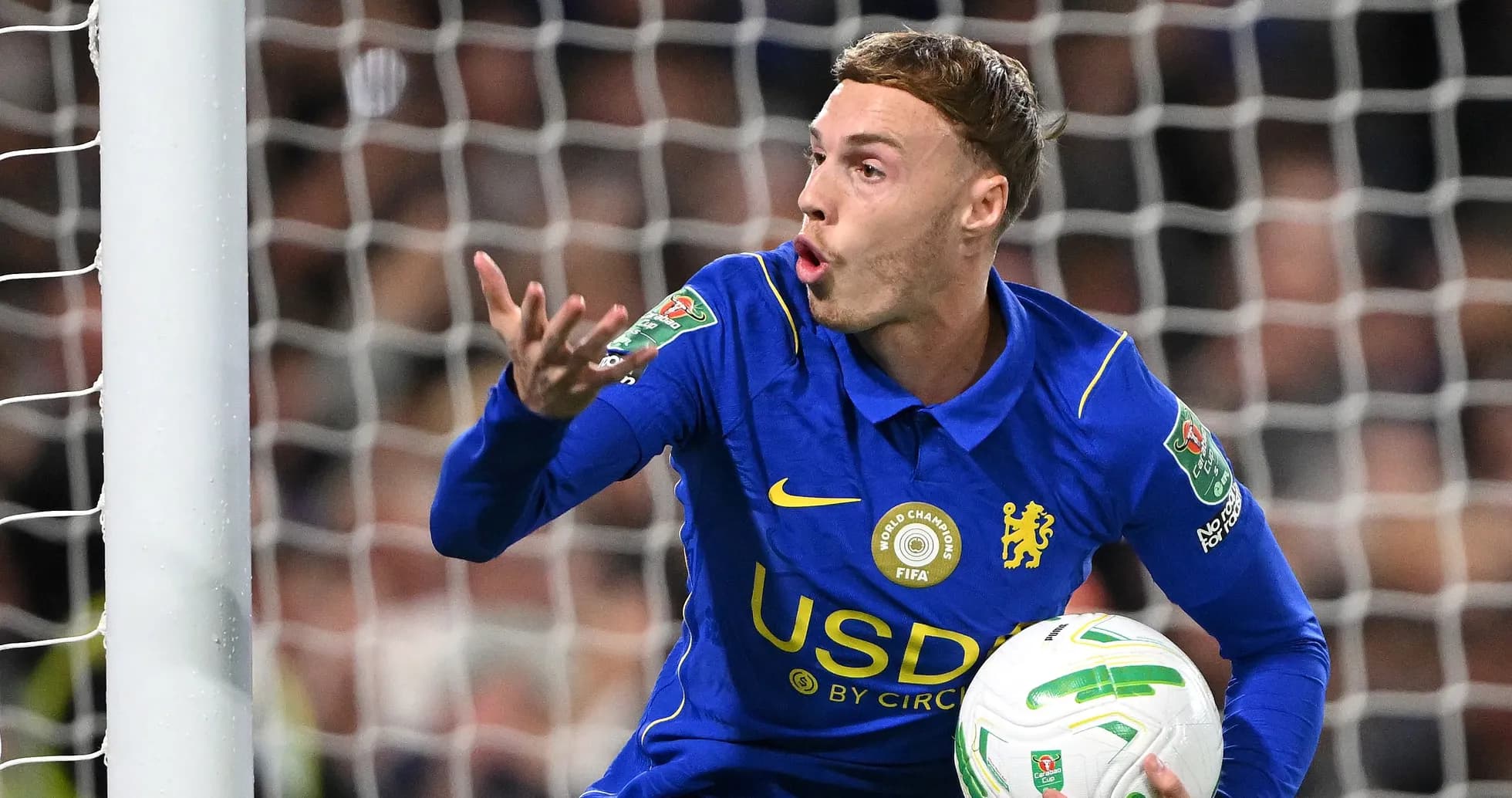 Player gesturing while holding ball during match