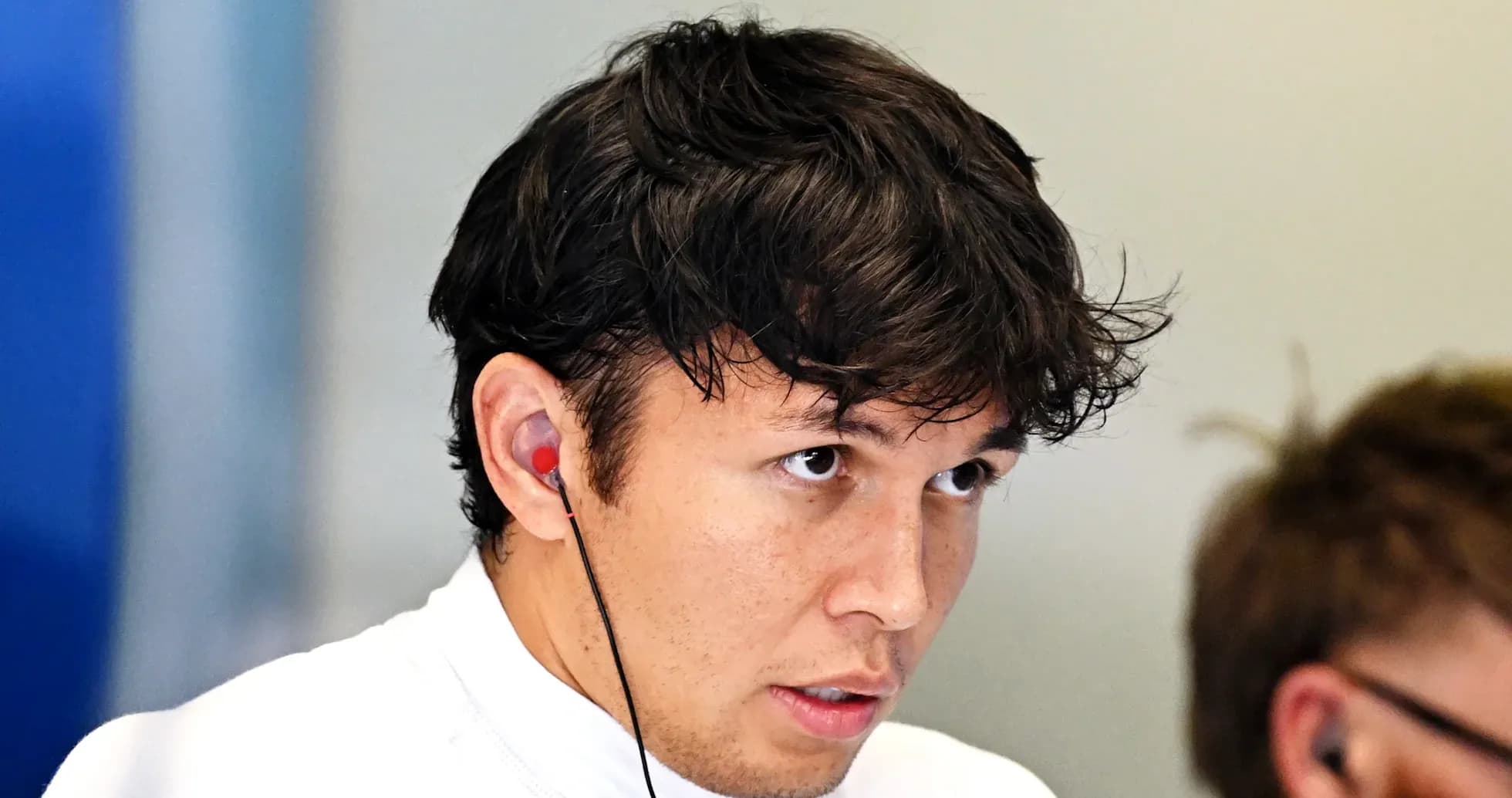Driver wearing earbuds during a team meeting