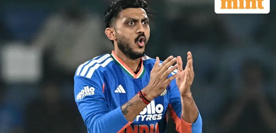 Cricketer gesturing during match in blue jersey