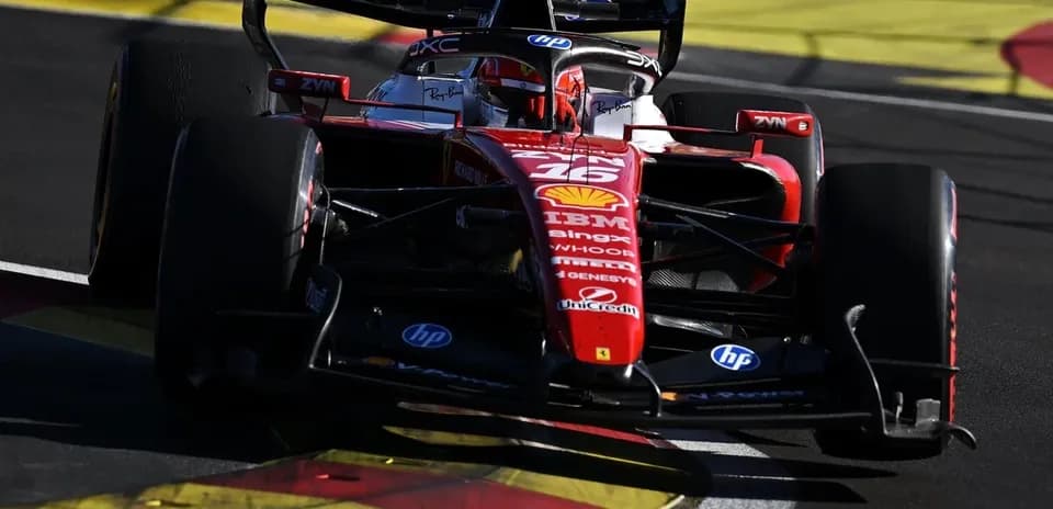 Ferrari F1 car navigating a corner on track