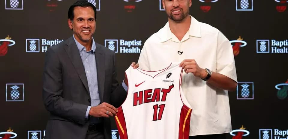 Coach and player presenting new Miami Heat jersey
