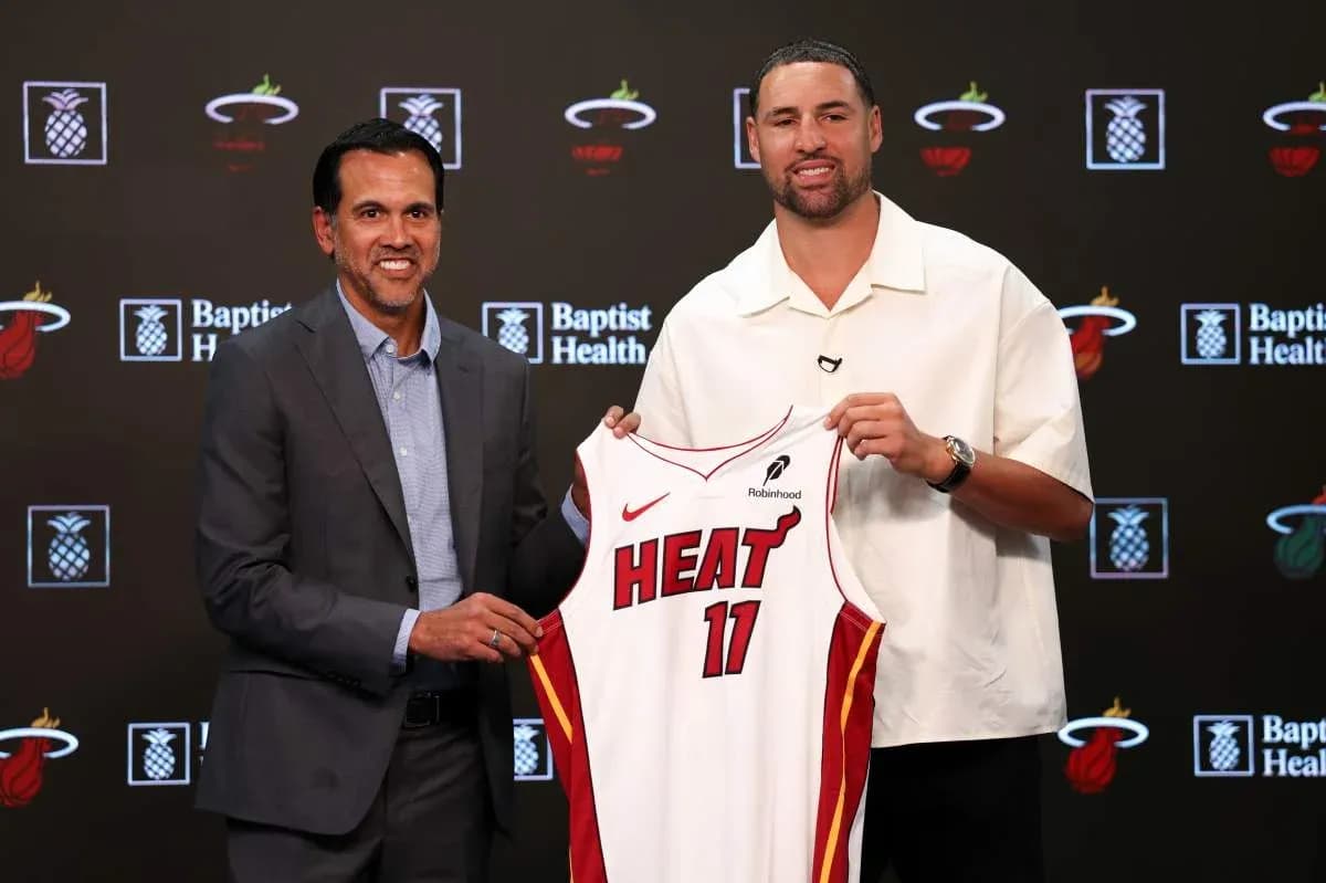 Coach and player presenting new Miami Heat jersey
