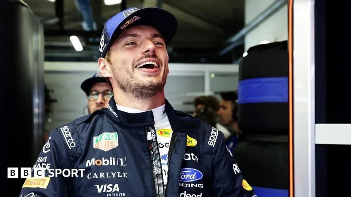 Driver smiling in the pit area during event