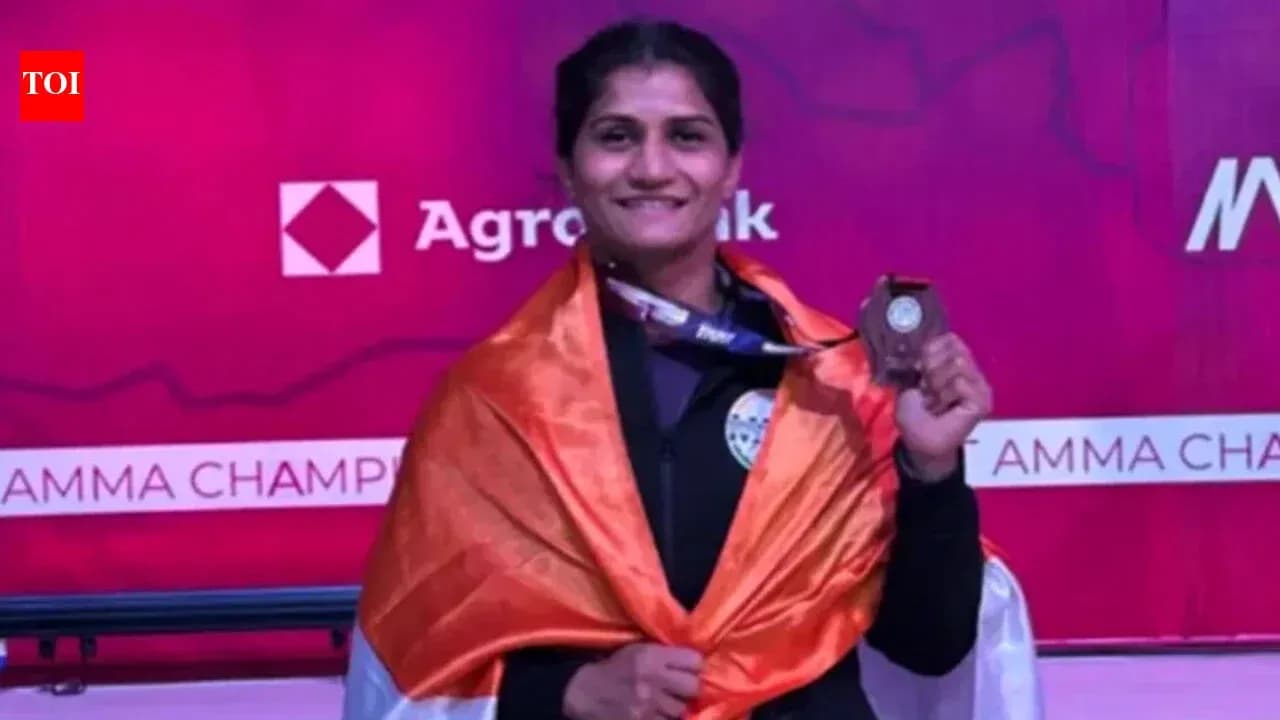 Athlete holding medal and draped in flag