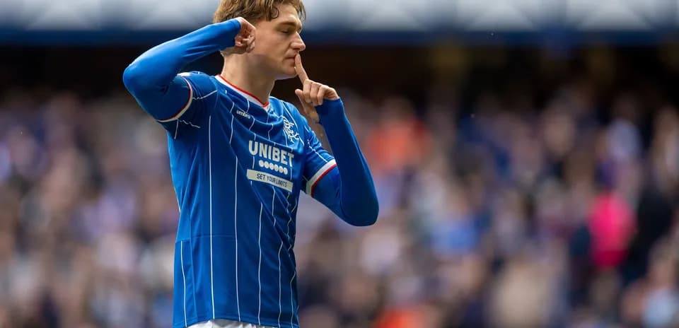 Player celebrating with shushing gesture after scoring