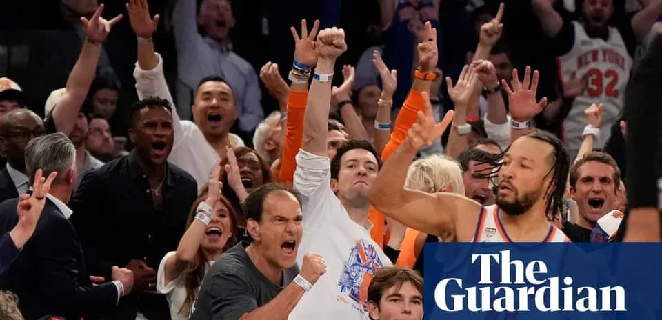 Excited crowd cheering at basketball game
