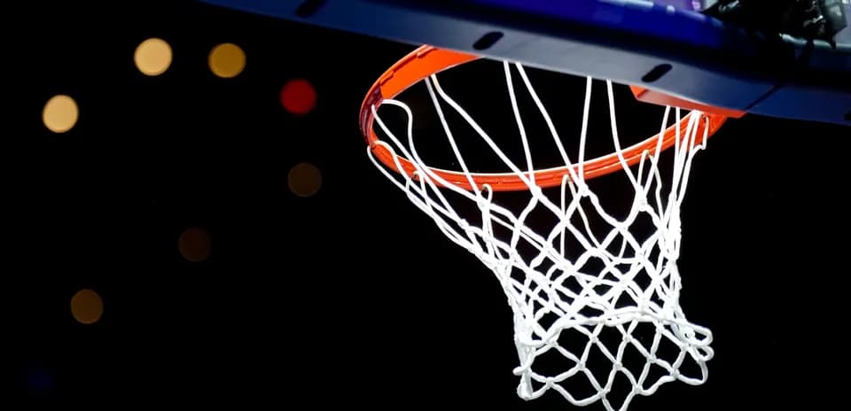 Close-up of basketball hoop against dark background